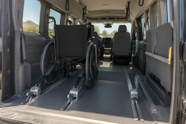 Padded interior of a medical transport van with secure wheelchair floor tracks in Mesa, AZ.