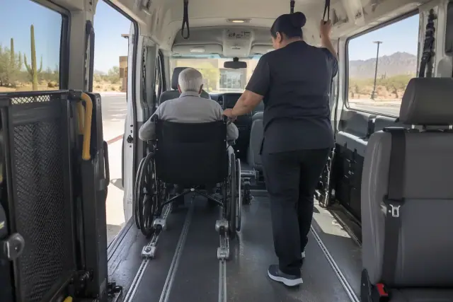 Interior cabin of a medical transport van with secure floor tracks and grab handles in Mesa, AZ.