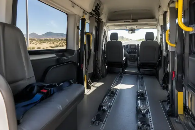 Medical transport van interior in Queen Creek, AZ, showing secure floor tracks and restraints.