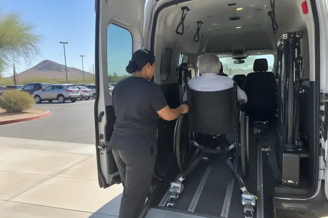 Medical appointment transportation vehicle interior in Mesa, AZ, showing secure floor tracks and overhead grab handles.