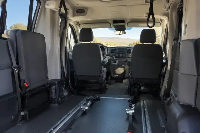 Interior of a medical transport van with floor tracks and grab handles in Sun Lakes, AZ.