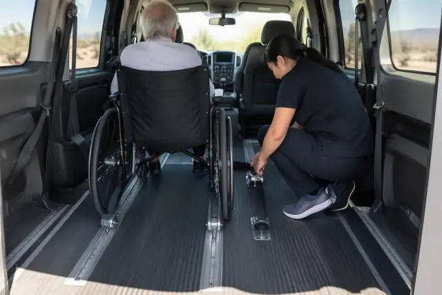 Physical therapy transportation van interior in Mesa, AZ, showing secure floor tracks and overhead grab handles.