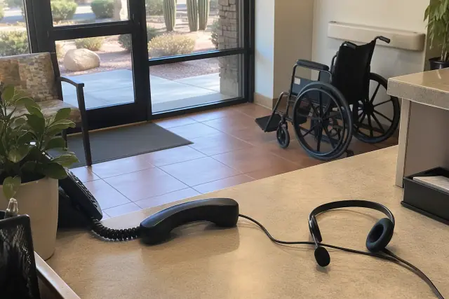 Headset and phone off the cradle next to a wheelchair in Mesa, AZ.