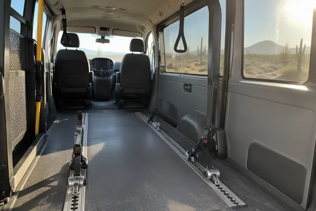 Wheelchair transport van interior with secure floor tracks and grab handles in Mesa, AZ.