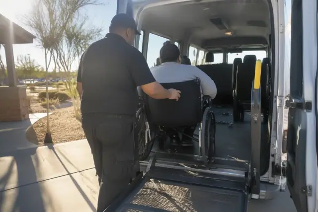 Vehicle interior and exterior during bariatric transportation service in Mesa, AZ, showing dust and sun glare.