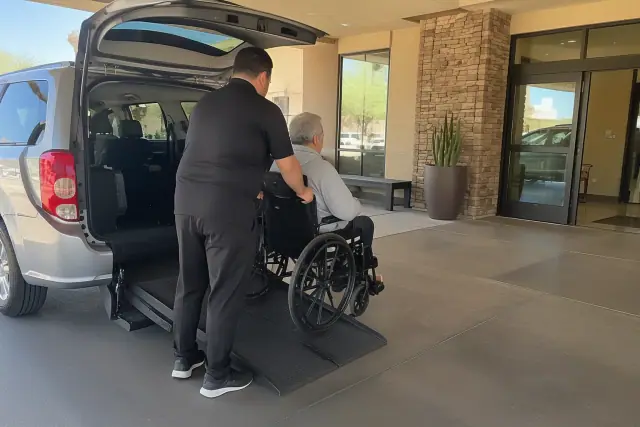 Recurring dialysis transportation at a covered drop-off lane in Mesa, AZ.