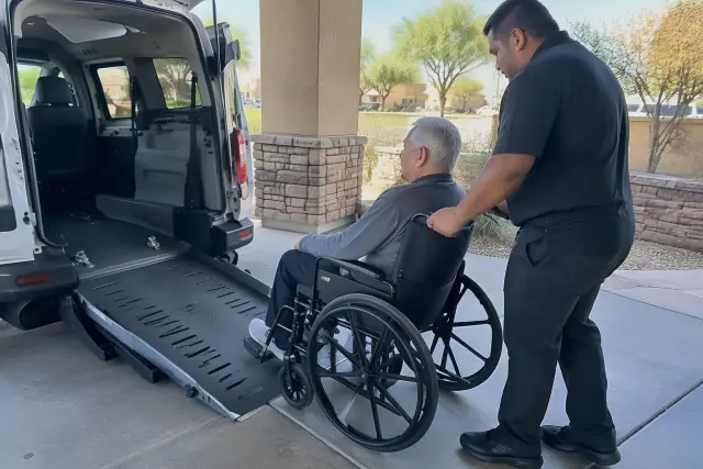 Wheelchair transportation service for recurring dialysis in Mesa, AZ, near a desert stone wall.