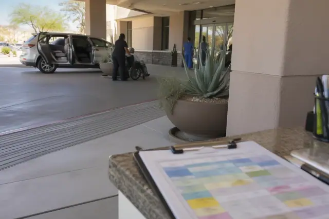 Clipboard with chemotherapy transportation ride plans at a cancer center in Mesa, AZ.