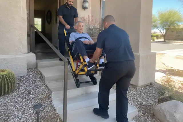 Stair chair assistance for dialysis transportation on a residential porch in Mesa, AZ.