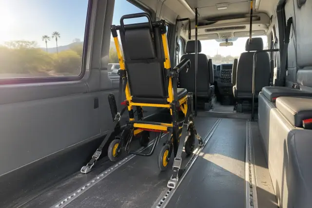 Stair chair secured inside a medical transport van with floor tracks in Tempe, AZ.