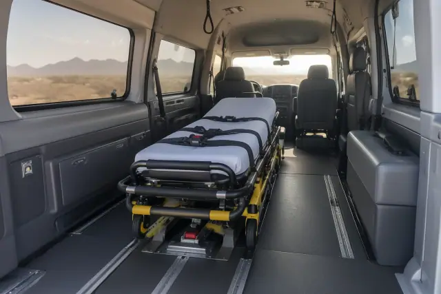 Medical transport stretcher secured to floor tracks inside a van in San Tan Valley, AZ.