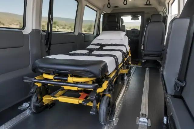 Medical transport stretcher secured with heavy-duty straps in a van interior in Gold Canyon, AZ.