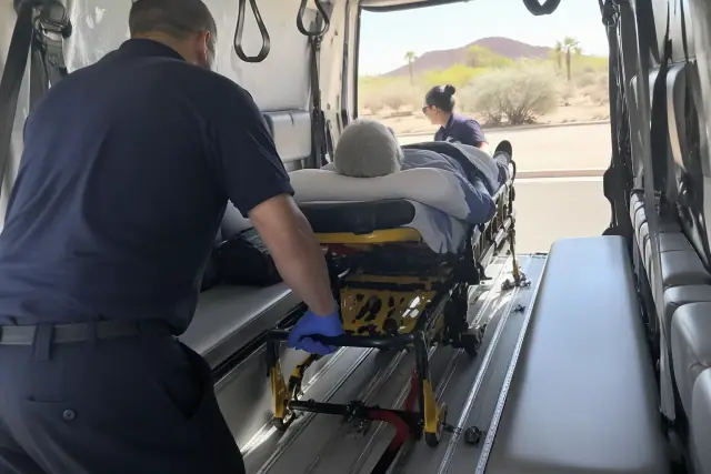 Stretcher transfer during a hospital discharge inside a medical transport vehicle in Mesa, AZ.