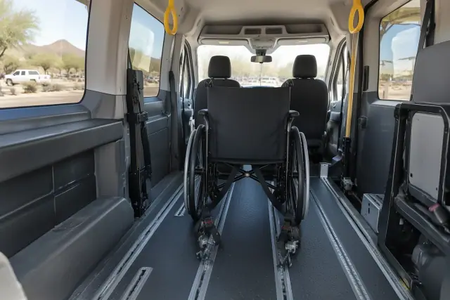 Wheelchair transportation setup with secure floor tracks inside a van in Queen Creek, AZ.