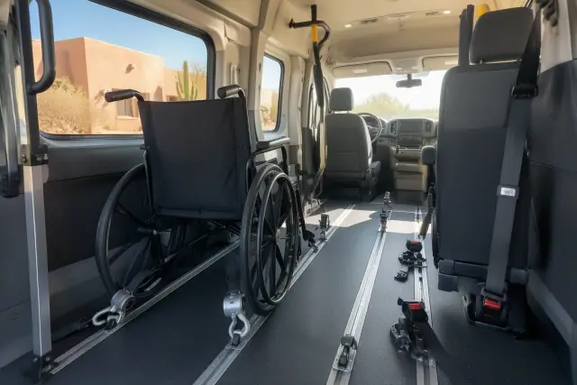 Interior of a wheelchair transportation van in Mesa, AZ, showing secure floor tracks and tie-downs.