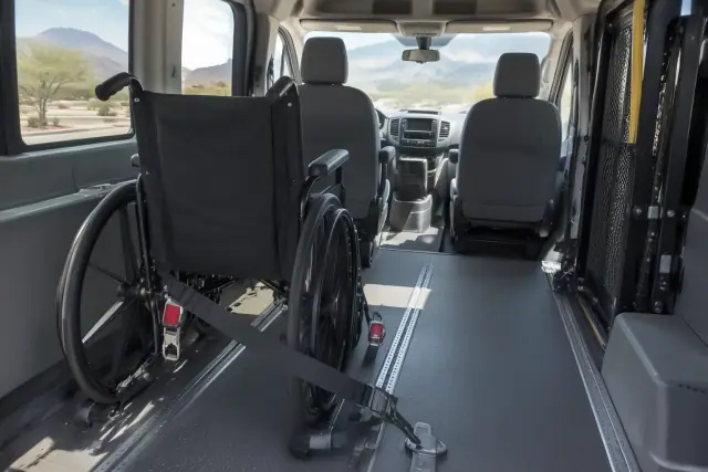 Wheelchair secured with floor tracks and safety straps inside a transport van in Mesa, AZ.