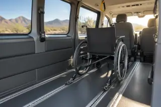 Padded wheelchair transport van interior with secure floor tracks in Mesa, AZ.