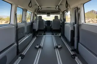 Wheelchair transport van interior featuring secure floor tracks and overhead grab handles in Mesa, AZ.