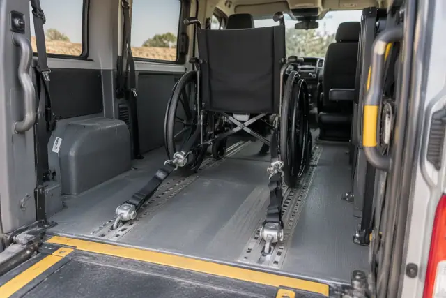 Wheelchair van lift and four-point restraints inside a vehicle in Mesa, AZ.