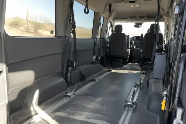 Wheelchair van interior cabin with floor tracks and securement equipment in Mesa, AZ.
