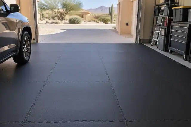 Heavy-duty rubber garage flooring matting installed in a residential vehicle bay in Mesa, AZ.