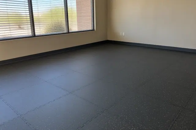 Commercial rubber floor tile installation with puzzle-edge seams at an office in Mesa, AZ.
