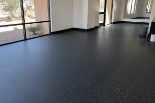 Clean rubber flooring expanse with neat seams and wall transitions in Mesa, AZ.