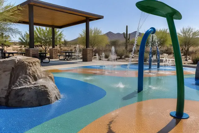 Poured-in-place rubber safety surfacing around playground equipment at a park in Mesa, AZ.