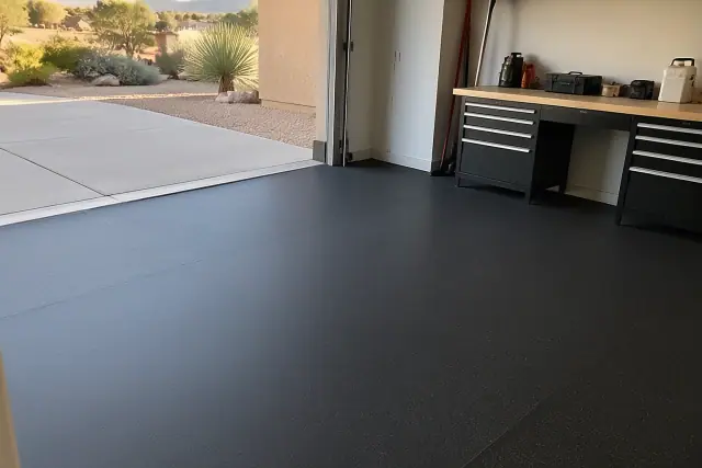 Heavy-duty rubber flooring installed in a garage in Fountain Hills, AZ, covering concrete and workbench areas.