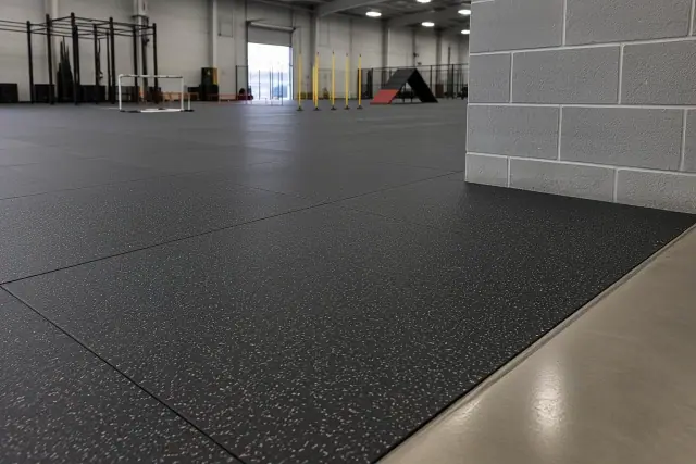 Glue-down rubber floor tiles installed on a concrete foundation at an indoor sports facility in Mesa, AZ.