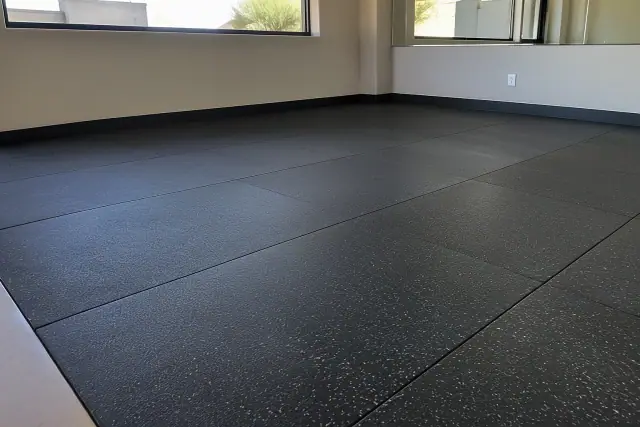 Interlocking rubber gym flooring installed in Phoenix, AZ, showing fitted tiles and clean edge trims.