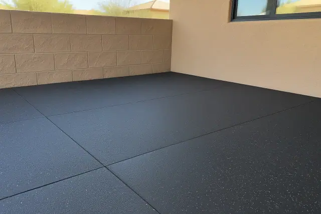 Thick rubber gym flooring installed along a stucco wall in Queen Creek, AZ.