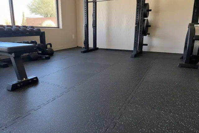 Completed rubber flooring installation in Mesa, AZ, showing dense interlocking seams and heavy texture.