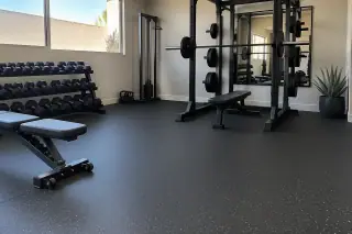 Rubber gym flooring installed under barbell racks in Mesa, AZ.
