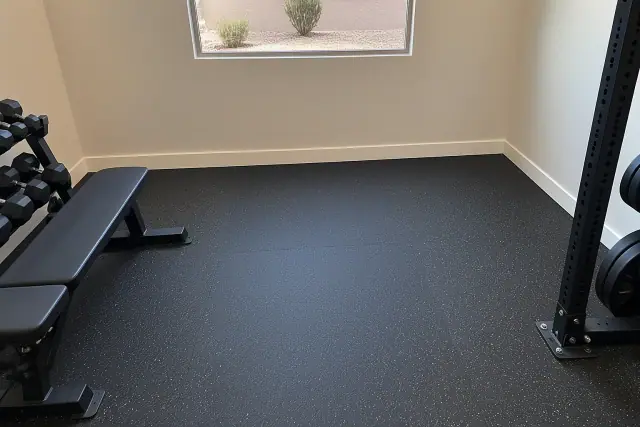 Contractor photo of heavy-duty rolled rubber flooring installed in a home gym in Mesa, AZ.