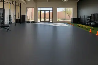 Dense rolled rubber flooring inside a large sports training facility in Mesa, AZ.