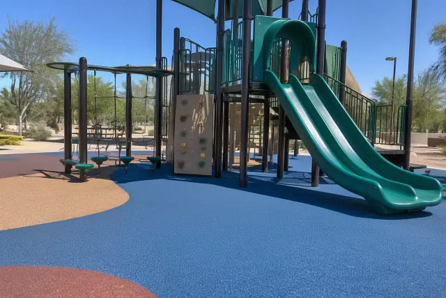 Seamless rubber safety surfacing beneath a playground climbing structure in Tempe, AZ.