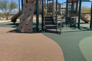 Seamless playground rubber safety surfacing beneath a climbing set in Mesa, AZ.