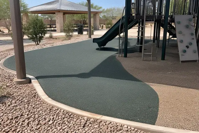 Playground rubber surface repair and recoating project in progress at an outdoor park in Mesa, AZ.