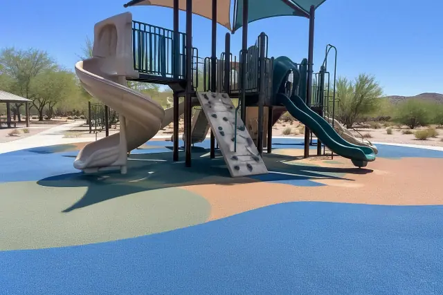 Poured-in-place rubber safety flooring beneath a playground structure in Phoenix, AZ.