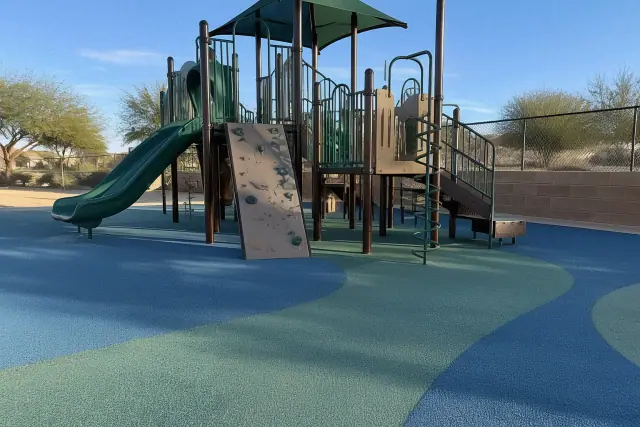 Poured-in-place rubber safety surfacing beneath a playground climbing structure in San Tan Valley, AZ.