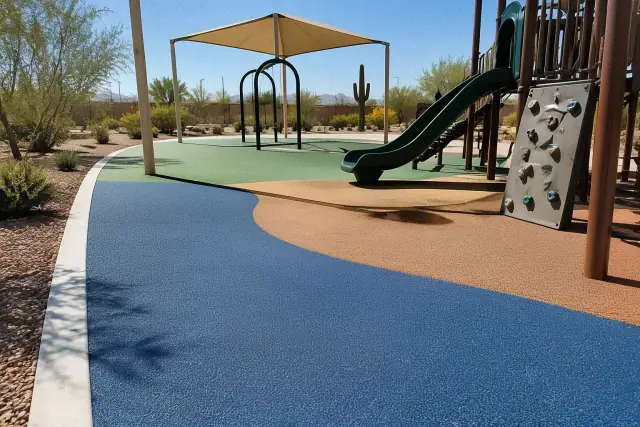 Poured-in-place rubber playground surfacing installation in Mesa, AZ, showing multi-colored safety rubber and concrete