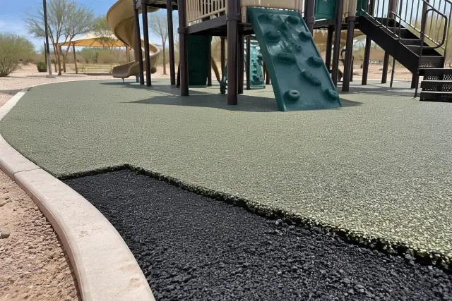 Poured rubber safety surfacing with black base and EPDM wear layer at a Mesa, AZ park play structure.