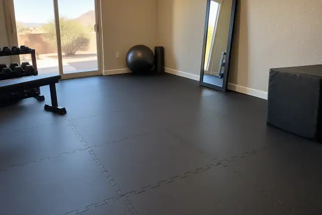 Precision-cut interlocking rubber tiles fitted tightly together in a Mesa, AZ basement exercise space.