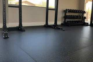Rolled rubber flooring installed under dumbbell storage stations in Mesa, AZ.