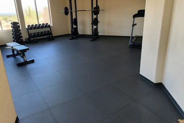 Rubber floor tile installation in a residential basement exercise space in Queen Creek, AZ.