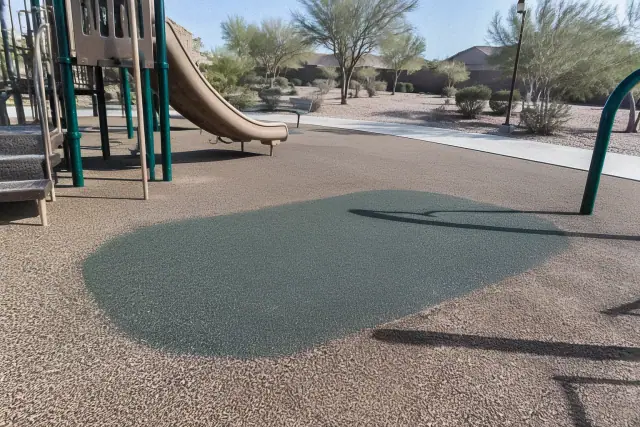 Freshly cured seamless rubber patch on a poured-in-place playground safety surface in Mesa, AZ.