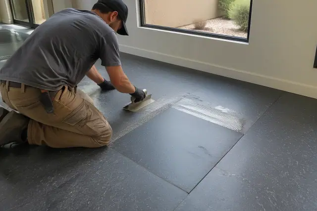 Technician repairing rubber flooring with a precise seam and fresh adhesive in Scottsdale, AZ.