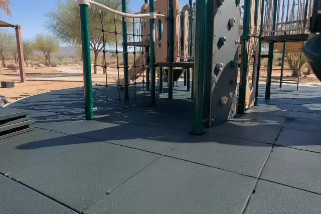 Interlocking rubber playground tiles installed under equipment at a community park in Mesa, AZ.