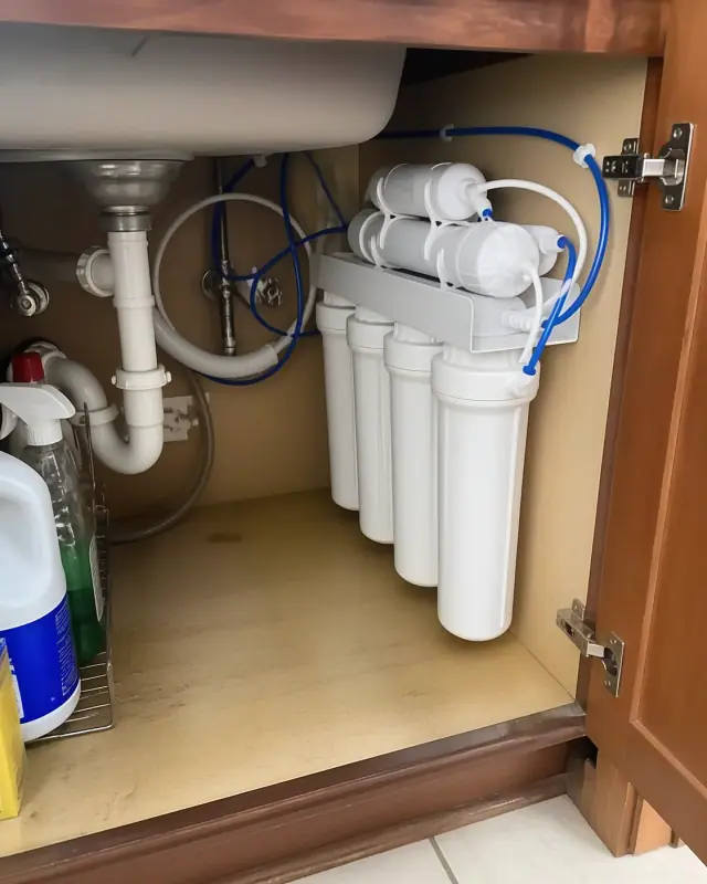 Under-sink water filtration system installed in a kitchen cabinet in Mesa, AZ.